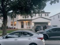 Charming two-story home with a manicured front yard, attached garage, and inviting front porch at 10148 Malpas Pt, Orlando, FL 32832