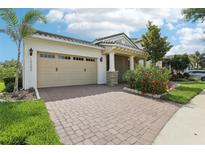 Charming single-story home with a brick driveway, lush landscaping, and a welcoming covered entrance at 10203 Henbury St, Orlando, FL 32832