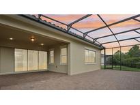 A covered patio with brick flooring, perfect for enjoying the outdoors, with a lovely sky view at 10203 Henbury St, Orlando, FL 32832