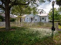Charming single story home with a picket fence and mature landscaping at 1102 S Oak Ave, Sanford, FL 32771