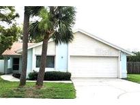 Charming one-story home with a two-car garage, featuring two palm trees in the front yard at 11373 Darlington Dr, Orlando, FL 32837