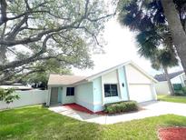 Charming single-story home with a well-manicured lawn and a light blue exterior at 11373 Darlington Dr, Orlando, FL 32837