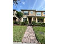 Inviting home exterior featuring a brick walkway leading to the front door and neat landscaping at 11464 Center Lake Dr, Windermere, FL 34786