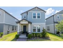 Charming two-story home with a covered front porch and lush landscaping at 12133 Bracco St, Winter Garden, FL 34787