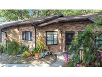 Charming brick townhome with well-maintained landscaping and inviting entrance, perfect for a cozy living space at 1803 Foxhall Cir # 1803, Kissimmee, FL 34741