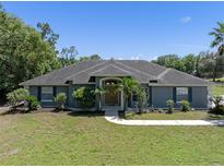 Charming single-story home with lush landscaping and a welcoming entrance at 2633 Pickett Downs Dr, Chuluota, FL 32766