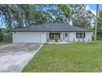 Charming single-story home featuring a well-maintained lawn and inviting front entrance at 37 N Tymber Crk, Ormond Beach, FL 32174