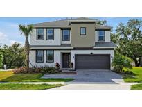 A charming two-story home boasts meticulous landscaping, a two-car garage and lush, mature landscaping at 4441 Ganesha Loop, Kissimmee, FL 34746