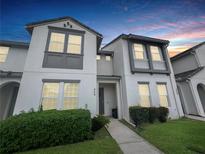 Charming two-story townhome featuring modern design and a well-manicured lawn at 454 Captiva Dr, Davenport, FL 33896