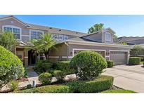Well-maintained home featuring lush landscaping and an attached two-car garage at 585 Cruz Bay Cir, Winter Springs, FL 32708