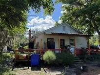 Charming home featuring a covered porch with red railing and colorful accents at 850 Menton Rd, Pierson, FL 32180
