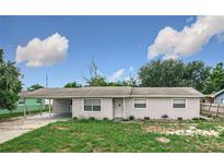 Attractive one-story home with well-kept landscaping and an attached carport on a sunny day at 116 7Th St, Winter Haven, FL 33880