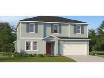 Charming two-story home featuring light blue siding, gray shutters, and a two-car garage at 1365 Inkberry Cir, Deland, FL 32720