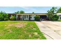 Charming single-story home with a well-maintained lawn and inviting front porch at 2504 Caribbean Ct, Orlando, FL 32805