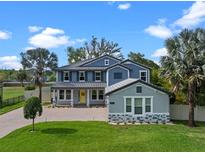 Charming two-story home with a well-manicured lawn and inviting front porch at 3865 W Stillwood Ln, Lake Mary, FL 32746