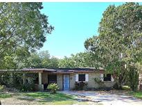 Charming single-story home with a front porch and mature shade trees at 5262 Lescot Ln, Orlando, FL 32811