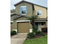 Inviting townhome with a well-maintained front yard and an attached garage at 626 Old Pine Ct, Sanford, FL 32773
