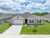 Charming single Gathering home with a manicured lawn and a two car garage at 715 Auburn Grove Ct, Auburndale, FL 33823
