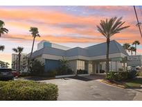 Stunning exterior view of Ocean Jewels Club with lush landscaping and palm trees at 935 S Atlantic Ave # 302, Daytona Beach, FL 32118