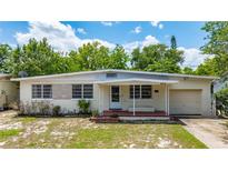 Charming single-story home with a covered porch and well-maintained front yard at 944 Essex Rd, Daytona Beach, FL 32117