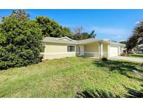 Charming single-story home featuring a well-maintained lawn and attached two-car garage at 10350 Sw 62Nd Terrace Rd, Ocala, FL 34476