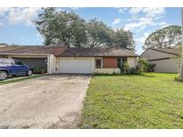 Charming single-story home with a well-maintained lawn, driveway, and attached garage at 109 Long Leaf Pine Cir, Sanford, FL 32773