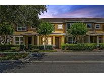 Charming townhome featuring mature trees, and manicured shrubs enhances curb appeal at 11213 Grander Dr, Windermere, FL 34786