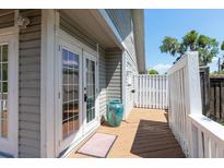 Wooden deck featuring french doors, white railings, and a light grey house exterior at 1308 S Pennsylvania Ave # 3, Winter Park, FL 32789
