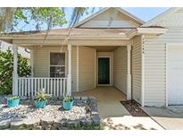 Inviting front porch with rock garden and quaint plants at 13146 Odyssey Lake Way, Orlando, FL 32826