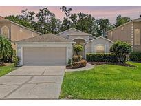 Charming single-story home features a two-car garage, landscaped yard, and beautiful curb appeal at 14780 Hartford Run Dr, Orlando, FL 32828