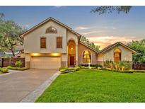 Inviting home with manicured lawn, water feature, and warm lighting at sunset at 1905 Old Club Pt, Maitland, FL 32751
