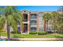 Inviting multi-story condo building with palm trees and well-maintained landscaping at 1979 Summer Club Dr # 111, Oviedo, FL 32765