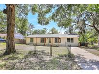 Charming single-story home featuring a fenced yard and neutral exterior paint with natural wood columns on the front porch at 2536 Nw 3Rd Ave, Ocala, FL 34475