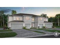 Beautiful two-story home showcasing a manicured lawn, multi-car garage and impeccable modern design at 2582 Winsome Way, Davenport, FL 33896