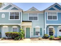 Inviting townhome exterior with colorful facade, well-kept landscaping, and charming curb appeal at 2935 Greenwood Springs Loop, Lake Mary, FL 32746