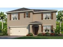 Charming two-story home with beige exterior, brown shutters, and a well-manicured lawn at 3137 Partington Blvd, Davenport, FL 33837