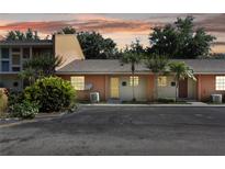 Inviting condo exterior with tropical landscaping and assigned parking at 4878 Tangerine Ave # 4878, Winter Park, FL 32792