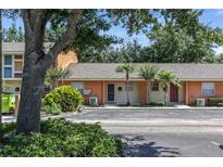 Cozy townhome featuring neutral paint, well maintained landscaping, and a parking area at 4878 Tangerine Ave # 4878, Winter Park, FL 32792