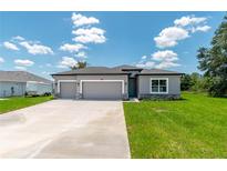 Charming single-story home featuring a three-car garage and neutral gray stucco exterior with stone accents at 506 Marion Oaks Trl, Ocala, FL 34473