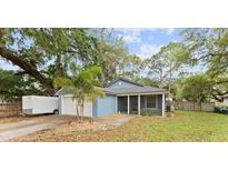 Charming single-story home with a well-maintained lawn and mature trees for shade at 6436 Fig Leaf St, Magnolia Square, FL 34771