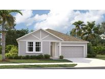 Charming single-story home featuring a light gray facade, well-manicured lawn and a two-car garage at 706 Junonia Blvd, New Smyrna Beach, FL 32168