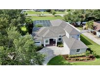 Stunning single-Gathering home features a screened-in pool, spacious driveway, and lush landscaping at 100 Demens St, Oakland, FL 34760