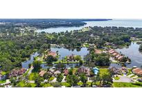 Stunning aerial view of waterfront homes surrounded by lush trees and tranquil waterways at 1085 Island Way, Leesburg, FL 34748
