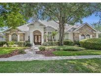 Charming single-story home with stone accents, lush landscaping, and a welcoming front entrance at 1158 Sweet Heather Ln, Apopka, FL 32712