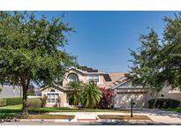 Charming two-story home with well-maintained lawn, mature trees, and a two car garage at 1201 Shelter Rock Rd, Orlando, FL 32835