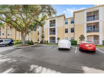 Multi-story condo building with ample parking, mature landscaping, and screened-in balconies at 1325 Lake Shadow Cir # 12303, Maitland, FL 32751