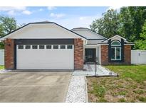 Charming single-Gathering home with a brick facade, attached garage and landscaped front yard at 1748 Harvest Cv, Winter Park, FL 32792