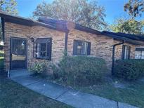 Charming brick home with black trim, and a well-maintained front yard at 1825 Foxhall Cir # 1825, Kissimmee, FL 34741