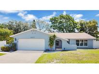 Charming single-story home featuring a well-maintained lawn, two-car garage, and a beautifully painted exterior at 3217 Castle Oak Ave, Orlando, FL 32808