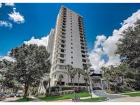 A tall, modern condominium building stands against a blue sky with scattered clouds at 530 E Central Blvd # 803, Orlando, FL 32801